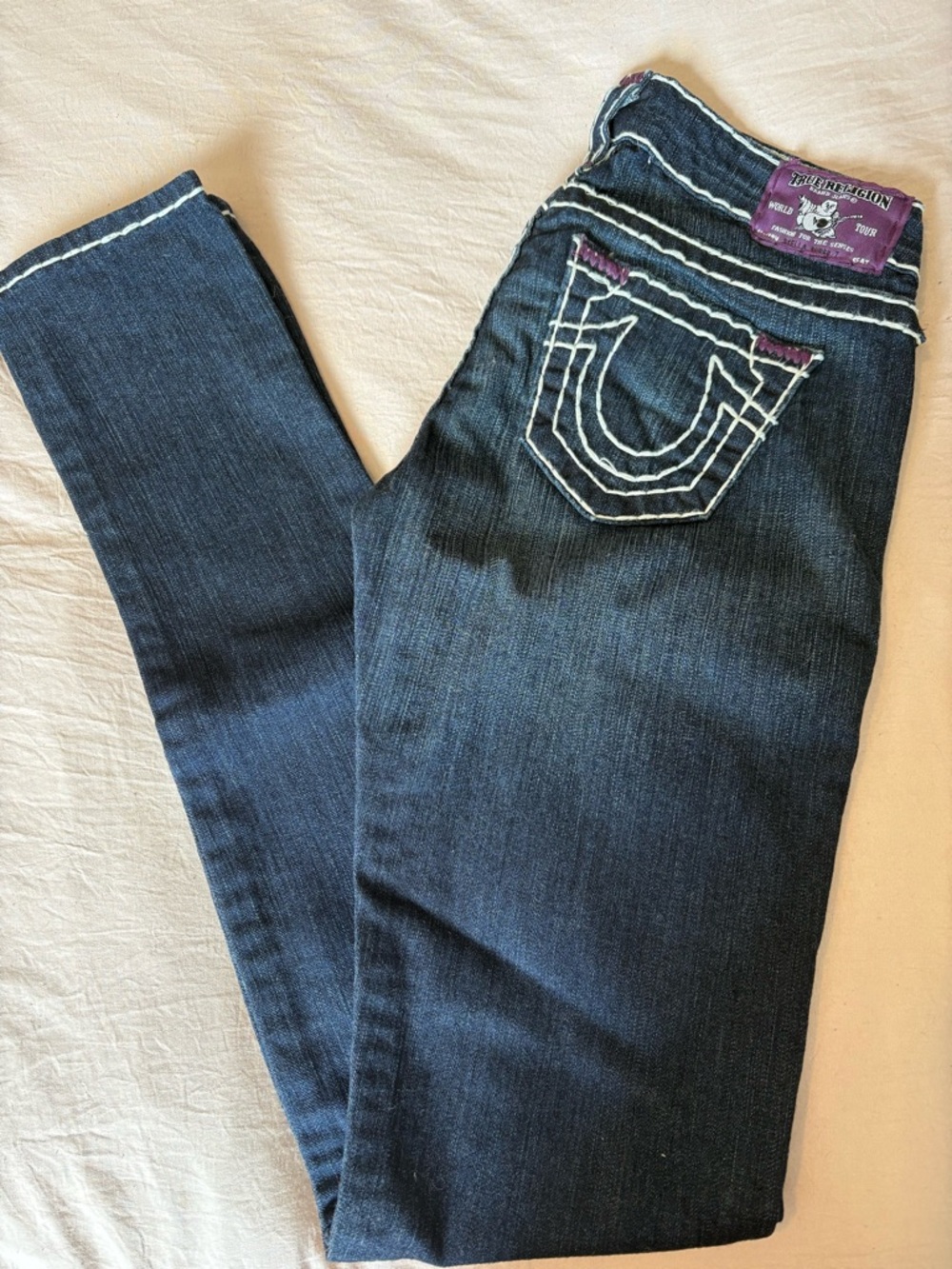 True Religion Dark Blue Skinny Jeans with White Stitching and Purple Patch